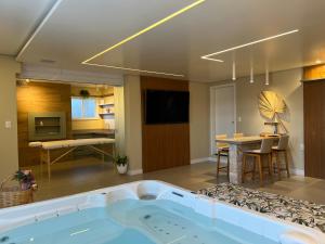 a large bathroom with a bath tub in a room at Chalé Alto da Serra - Pousada & Wellness Spa in São Joaquim