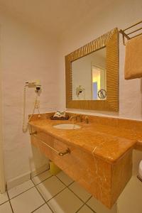 a bathroom with a wooden sink and a mirror at Hermoso alojamiento en los Tules, frente al mar en medio de hermosos jardines, es Unico!!! in Puerto Vallarta