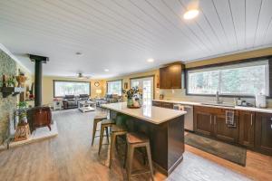 a kitchen with a large island in the middle of a room at Scenic Priest Lake Vacation Rental Deck and Views! in Vans Corner