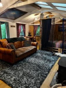 a living room with a couch and a bed at Off the Beaten Shack in North Hill