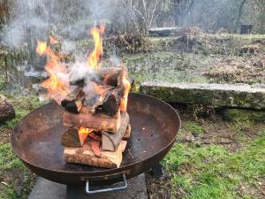 a fire in a grill in a yard at Off the Beaten Shack in North Hill