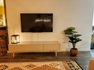 a living room with a flat screen tv on a wall at Big 88m2 apartment in the center in Rovaniemi