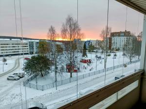 a view from a window of a city in the snow at Big 88m2 apartment in the center in Rovaniemi