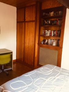 a bedroom with a bed and a desk and a book shelf at Chelles - Paris - Disneyland Marne la vallée in Chelles