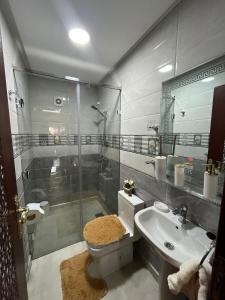 a bathroom with a shower and a toilet and a sink at APPART HOTEL OUED EDDAHAB in Khenifra +12 photos