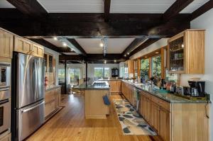 a large kitchen with wooden cabinets and stainless steel appliances at Eastside Eden A Wine Country Escape in Healdsburg