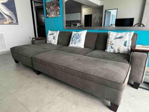 a brown couch sitting in a living room at Atlantis Spacious Loft-Sea view in San Juan