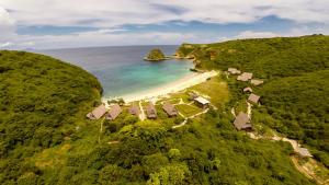 an aerial view of a beach with houses and the ocean at Jeeva Beloam Beach Camp in Tanjung Ringgit