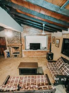 ein großes Wohnzimmer mit Sofas und einem Kamin in der Unterkunft Posada San Miguel in Paraguarí