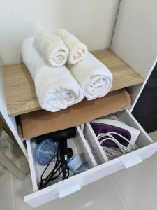 two towels are sitting on a shelf in a room at The Seashore House, The Shore Kota Kinabalu in Kota Kinabalu