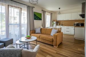 a living room with a couch and a table at Na Kubínke, Hillside in Dolný Kubín
