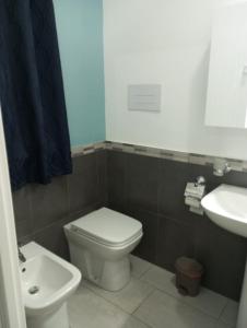 a bathroom with a white toilet and a sink at B&B Villa Kairos in Agrigento