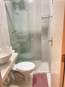 a bathroom with a shower and a toilet and a sink at Jr FLATS in João Pessoa