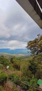 a view of a hill with trees and the ocean at EcoCasa Romantica vista a Cali disfruta en pareja o familia in Yumbo
