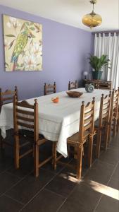 a dining room table with a white tablecloth and wooden chairs at Quinta De Gestacos in Geres