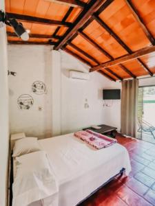 En eller flere senge i et værelse på Posada San Miguel