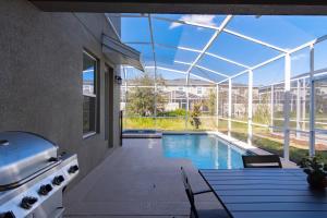 a swimming pool inside of a building with a glass ceiling at Beautiful 5bedroom house close to Disney 8943 in Kissimmee