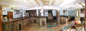 a living room with a couch and a table at Auberge des peupliers Café Restaurant in Akhendachou nʼAït Ouffi