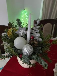 a christmas arrangement in a vase on a table at VILA DAVELY in Câmpulung Moldovenesc