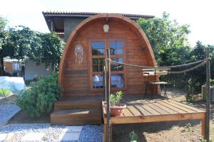 a wooden hobbit house with a wooden deck at Casa da Avó Miquinhas in Paços de Ferreira