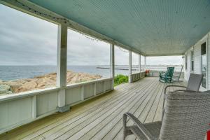 a porch of a house with chairs and the ocean at Historic Cottage w/ Beautiful Oceanfront View in Marshfield