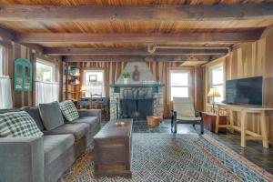 a living room with a couch and a fireplace at Historic Cottage w/ Beautiful Oceanfront View in Marshfield