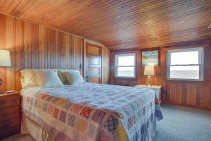 a bedroom with a bed and a wooden ceiling at Historic Cottage w/ Beautiful Oceanfront View in Marshfield