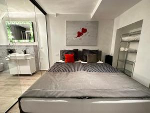 a bedroom with a large bed and a sink at BeeFree WhirlpoolSuite34-Free Parking & Fast Internet in Passau
