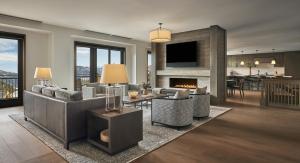 a living room with a couch and a fireplace at Montage Big Sky in Big Sky