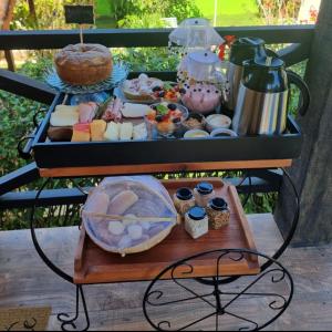 a tray of food on top of a table at Pousada do Figa in Visconde De Maua