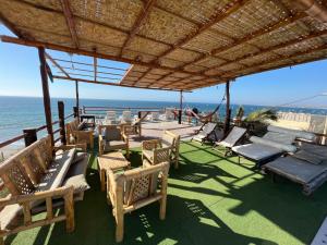 a patio with chairs and a view of the ocean at Casa Hotel Pacific Máncora - Piscina & Playa in Máncora