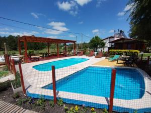 a swimming pool with a fence around it at Las Glicinas in Federación
