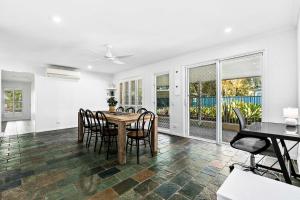 a dining room with a table and chairs at WhiteSands Beachouse in Urangan