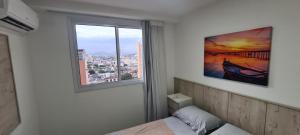 a room with a bed and a window with a view at Top Wave Itapoã 2 (702s) in Vila Velha +47 photos