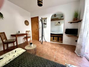 a bedroom with a bed and a room with a table at La Tejita Studio in La Tejita