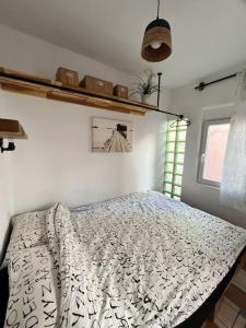 a bedroom with a bed with a white comforter at La Tejita Studio in La Tejita