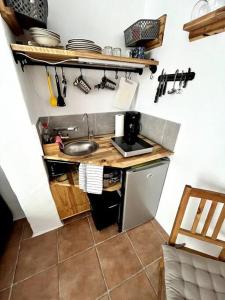 a small kitchen with a sink and a counter at La Tejita Studio in La Tejita
