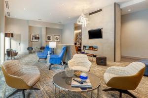 a living room with chairs and a couch and a tv at Residence Inn Providence Downtown in Providence