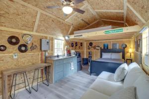 a living room with a couch and a bed in a room at Tree-Lined Higden Retreat Close to Parks and Trails in Fairfield Bay