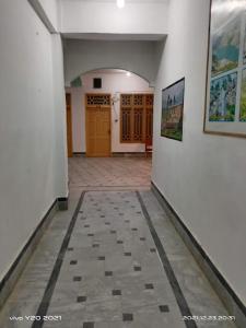 a hallway of a building with a tile floor at Sameer Hotel in Swat