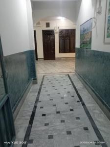 a hallway with a tiled floor in a building at Sameer Hotel in Swat