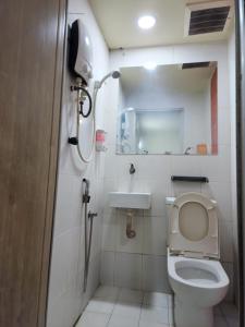 a bathroom with a toilet and a sink at 24Seven Guesthouse in Kuala Lumpur