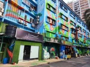 a building with a mural on the side of it at 24Seven Guesthouse in Kuala Lumpur