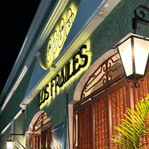 a lit up sign on the side of a building at Los Frailes Concept Hotel in Valladolid