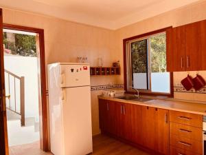 a kitchen with a white refrigerator and a sink at Casa Palmar in Valle Gran Rey