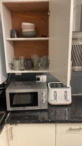 a microwave oven sitting on a kitchen counter at RAHAL OUTRAM in London