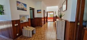 a hallway of a house with wooden floors and a table at Altillo Vista Mar in Moya +20 photos