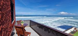 a balcony with a table and a view of the ocean at Altillo Vista Mar in Moya