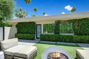 a backyard with a fire pit in the yard at Canyon Palms Estate- Ultra-Luxe, Pool, Spa, Firepit, Outdoor Kitchen & More in Palm Springs