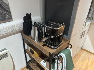 a kitchen counter with a coffee maker on a table at Chic Citispace -1-Bed Apartment Leeds City-WiFi in Leeds